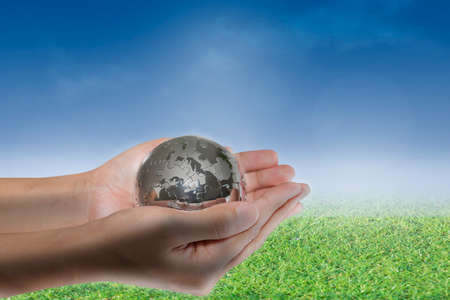 Planet in human hands on nature background. environment concept.の写真素材
