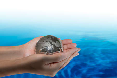 Planet in human hand over blurred beautiful  nature background. Earth Day,の写真素材