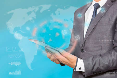 Businessman hand working with modern technology digital tablet computer and digital layer effect as business strategy conceptの写真素材