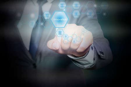 Businessman pressing button on touch screen interface and select  innovation. Business concept.の写真素材