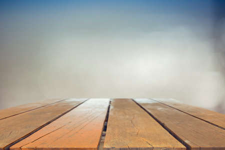 Wood table top on blurred blue sea background - used for display or montage your products. Vintage...
