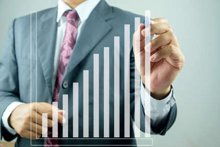 Businessman drawing graphics a growing graphの写真素材