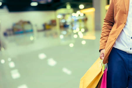 Happy shopping, male man hand holding shopping bags - Vintage Filterの写真素材