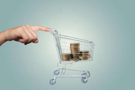 Hand with shopping cart of moneyの写真素材
