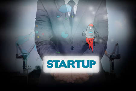 Text "startup" in the hands of a businessman. Business conceptの写真素材