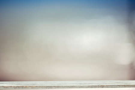 Wood table top on blurred blue sea background - used for display or montage your products. Vintage effect filter style picturesのeditorial素材
