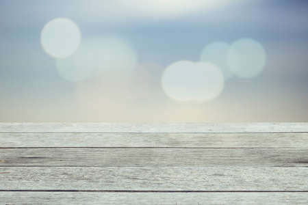 Wood table top on blurred blue sea background - used for display or montage your products. Vintage effect filter style picturesの写真素材