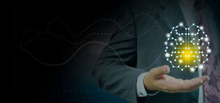Young businessman holding  holding a brain hologram,Brain representing creativity, innovation and similar with futuristic design.のeditorial素材