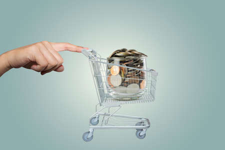 Hand with Shopping cart of moneyのeditorial素材