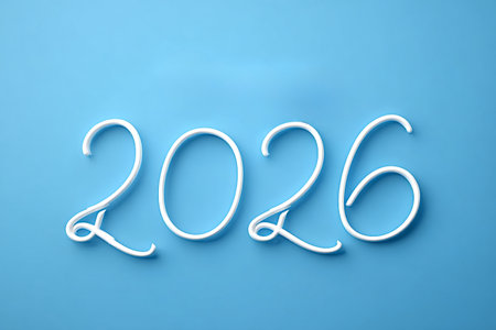 White calligraphic 2026 on a bright blue background symbolizing the upcoming new year, celebration,...