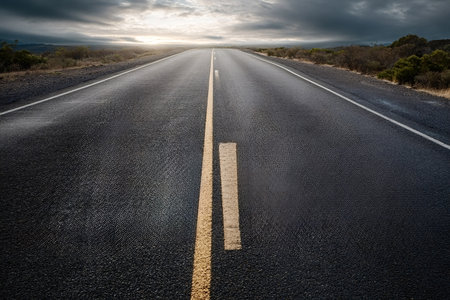 Asphalt highway extending into the distance under a dramatic stormy sky, symbolizing future,...