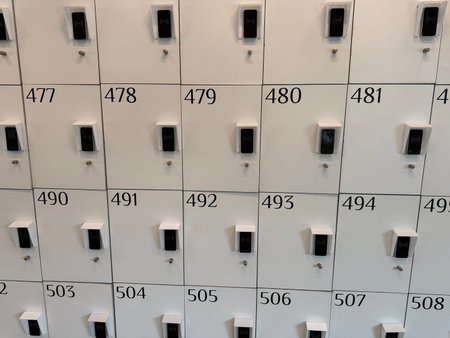White lockers providing secure storage with individual numerical codes and modern rfid contactless...