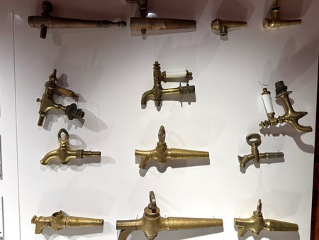 Collection of antique brass spigots and taps showcasing the historical development and variety of...