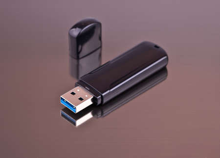 USB Flash drive on a gray background from aluminum for your siteの写真素材
