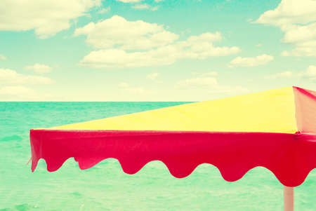 beach umbrella on the sea background, vintage retro styleの写真素材