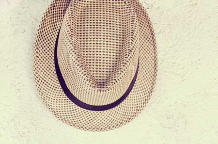 hat hanging on an old  wall vintage retro effect