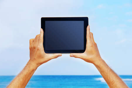 hands holding a tabletの写真素材