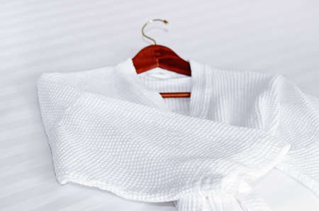 white bathrobe on the bedの写真素材