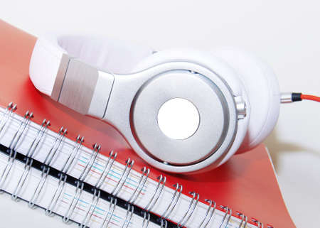 headphones and notebook on the desktopの写真素材
