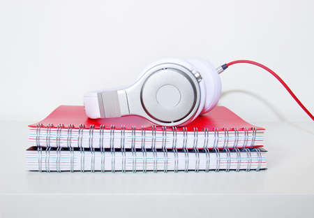 headphones and notebook on the desktopの写真素材