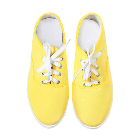 yellow sneakers isolated on white backgroundの写真素材