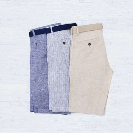 Male summer shorts isolated on a white wooden backgroundの写真素材