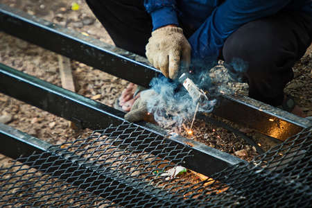 Welder welding steel mesh by electrode with electric arc.の写真素材