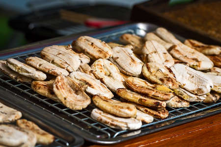 baked whole bananas for sale, roasted bananas for sell in fresh market Bangkok, Street food at thailand.の写真素材