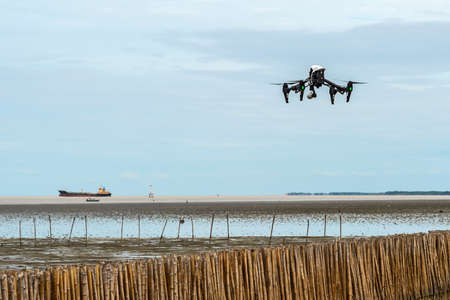 Drone explores bamboo barrier, protection seawater and wave at the estuary, Bright sky, Bangkok sea view. Mangrove ecological tourism of Thailand.のeditorial素材