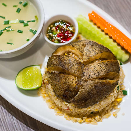 Fried rice with fried fish.の写真素材