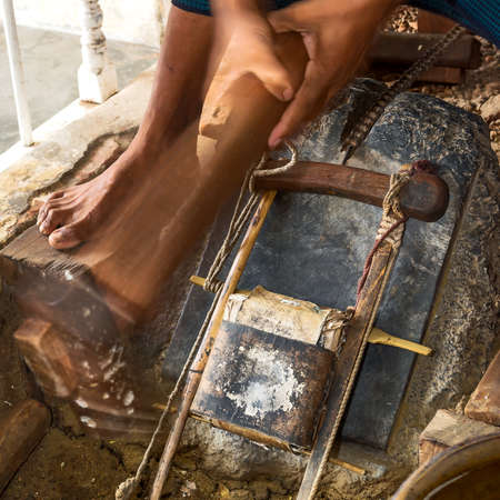 Craftsman punching gold in the traditional way to make leaf gold.の写真素材