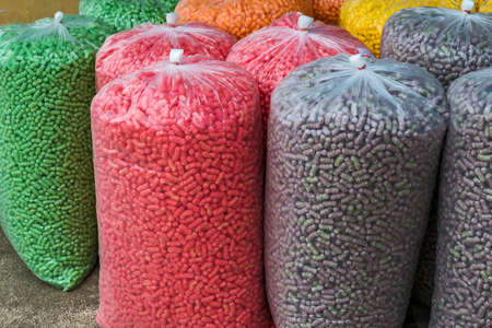 Feeding fish, colourful food for fish made from corn, popular for feeding the fish in the temple or shrine. colourful fish food pattern and background, soft focus.の写真素材
