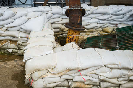 Sandbag and water sucker to prevent flooding in the rainy season.の写真素材