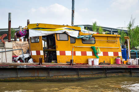 Steel boat in the river was converted into a living.の写真素材