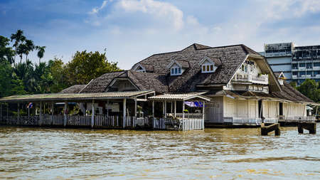 Bangkok - October 31: Old house along the Chao Phraya River in the rainy season on October 31, 2017 in Bangkok, Thailand.のeditorial素材