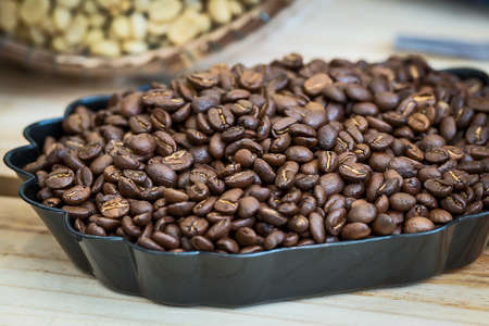 Raw coffee beans on the wooden table.の写真素材