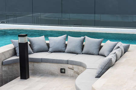 Sofa with cushion at outdoor water garden.の写真素材