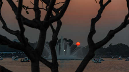 Sunset in the water park People have fun playing water bikes.の写真素材
