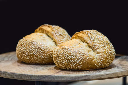 Sesame Buns (homemade) on a wooden table.の写真素材