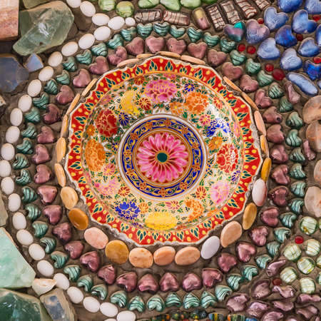 Colorful ceramic pattern background made from pebble and ceramic on the wall.