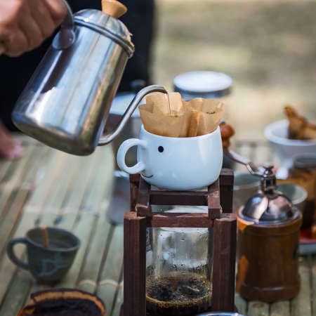Hand drip coffee , Barista pouring water on coffee ground with filter.の写真素材