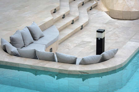 Sofa with cushion at outdoor water garden.