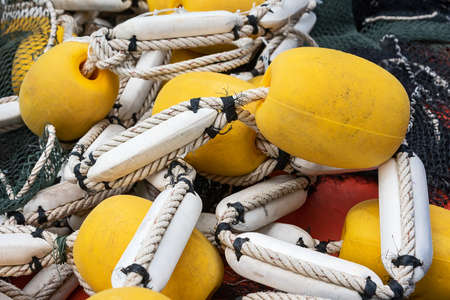 Industrial fishing net with large yellow floats.