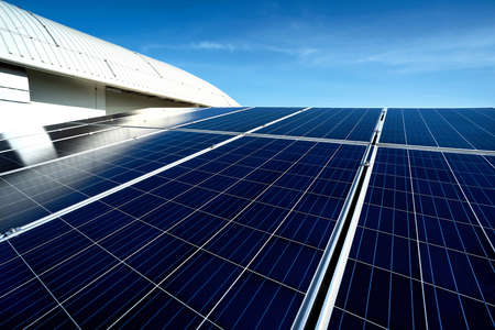 Solar panel on blue sky background. Roof and cloudy sky. Alternative energy concept.