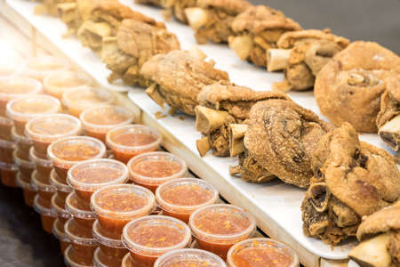 German Pork Legs that are fried until crispy and many dipping sauces ready to be served to customersの写真素材