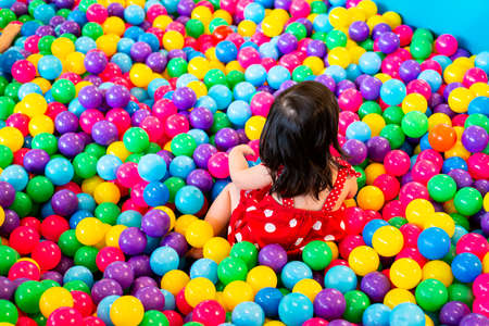 Children play in colored plastic balls