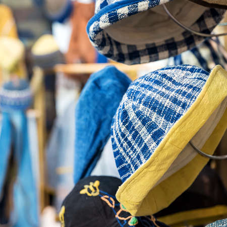 Street market selling hats and souvenirs in the tourist town of Thailandの写真素材