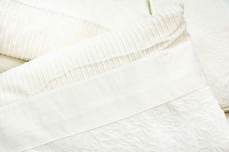 The clean white pillows are stacked together.の写真素材