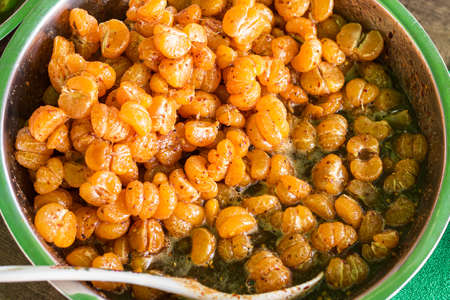 Tangerine Fruit Salad With hot sauce, salt and sugar dip in a bowl Is a fruit of Thai desserts that are sold in the market Street food in Bangkok, Thailandの写真素材