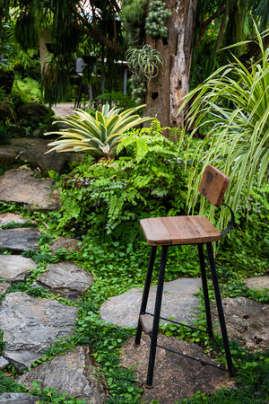 Black steel leg bench in palm garden to relaxの写真素材